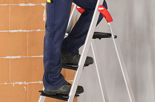 A man is climbing a folding step