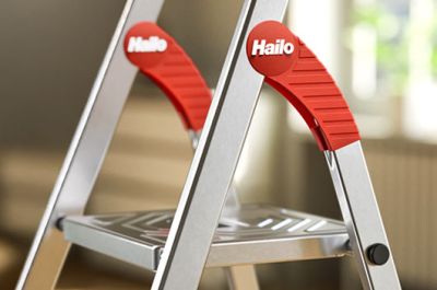 A man is climbing a folding step