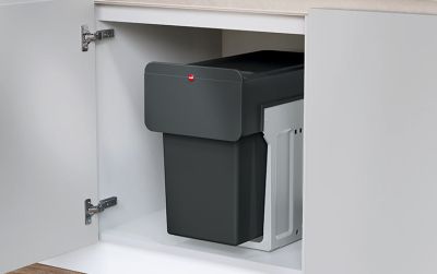 Waste separation bin in an open kitchen base cabinet