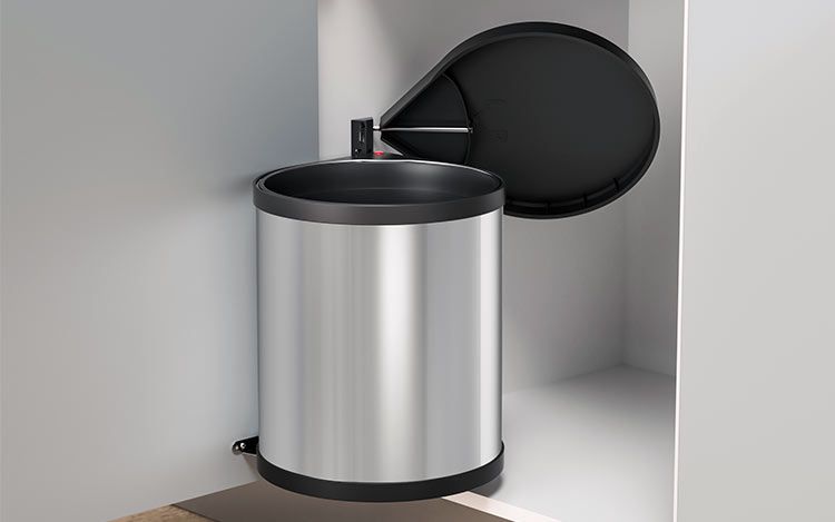 An open built-in waste bin in stainless steel