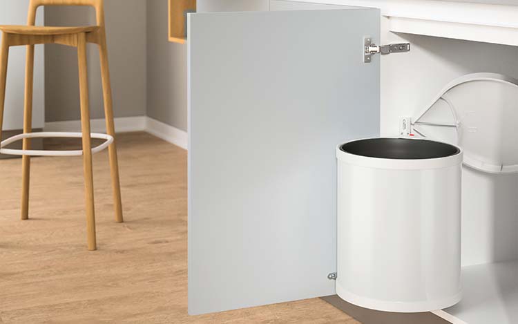 Waste bin in an open kitchen base cabinet